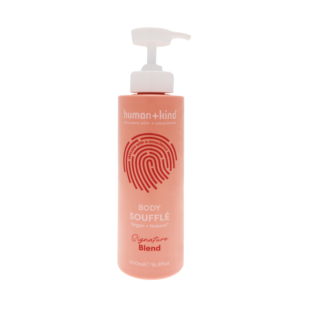 Pink bottle of human+kind body souffle on a white background