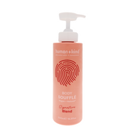 Pink bottle of human+kind body souffle on a white background